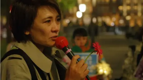 BBC News/Jiro Akiba Minori Kitahara at a Flower Demo protest in Japan