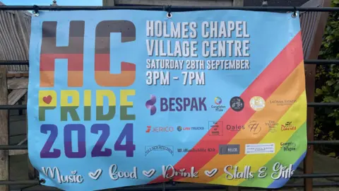 A colourful banner advertising Holmes Chapel Pride on Saturday 28 September at the Village Centre.