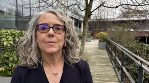 Woman in glasses by canal