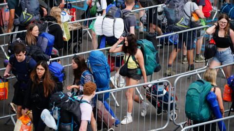 Image of queues of people attending Glastonbury in 2023