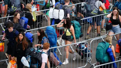 PA Media Image of queues of people attending Glastonbury in 2023