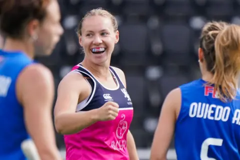 Getty Images Hockey player Sarah Robertson wears big smile and punches the air after scoring in a hockey game.