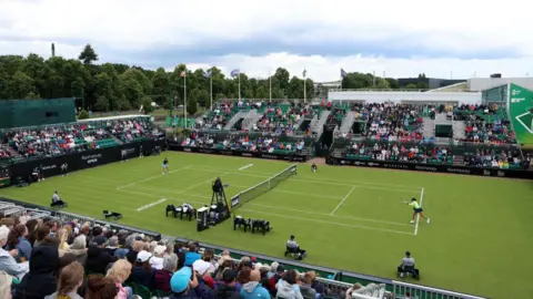 Crowd of people watch Nottingham Open tennis match