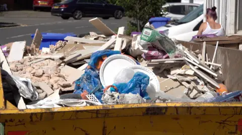 A skip full of rubble and rubbish