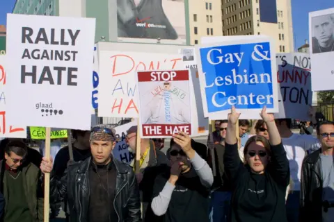 Getty Images Protesters hold up signs during The Rally Against Hate to push back against Eminem's lyrics ahead of the 2001 Grammy