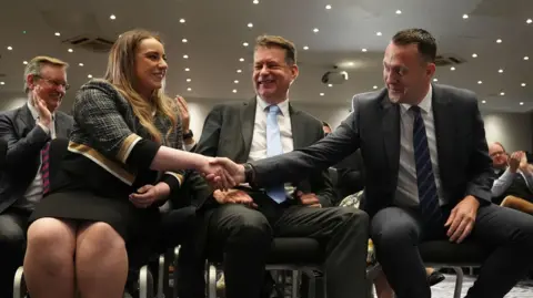 PA Media Russell Findlay shakes hands with defeated candidate Meghan Gallacher after the result is announced