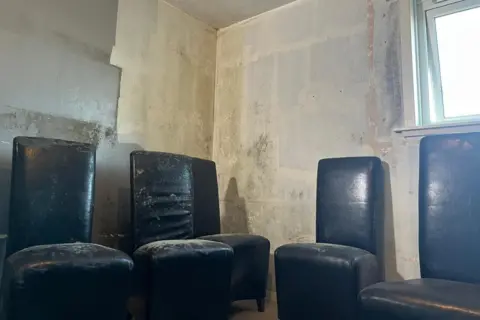 Gary Bennett Mould on black seats inside a flat.