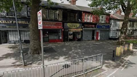 A Google Maps Street View of a parade of shops, with Stanely Park News in the centre. 