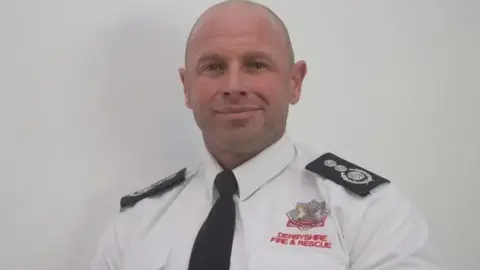 Derbyshire Fire and Rescue Service Rob Taylor in a white shirt and black tie