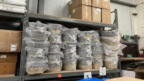 Baby Basics A picture of woven baskets stacked up on shelves in a warehouse 