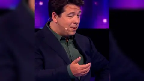 Michael McIntyre mimes checking his phone