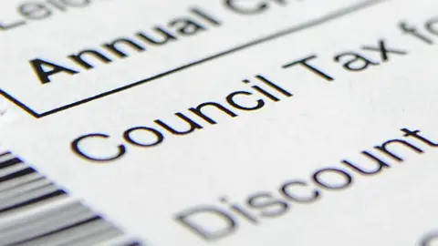 A letter which says council tax and discount. Parts of the letter is blurred. 