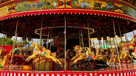Black Country Living Museum A bright and colourful carrousel ride with 30 wooden horses and two chariots with bench seats.