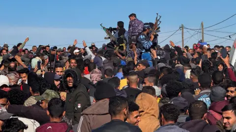 Reuters Crowds and Hamas police officers in Gaza