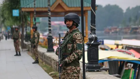 An Indian paramilitary soldier guards along the banks of Dal Lake in Srinagar, Jammu and Kashmir, on May 9, 2025.