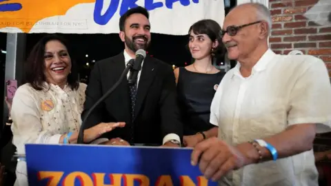 Reuters Zohran Mamdani reacts next to his parents Mahmood Mamdani and Mira Nair and wife Rama Duwaji during a watch party for his primary election