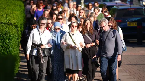 PA Media Interfaith activists of all multiple denominations, take part in a peaceful women's walk from through Golders Green, north-west London, on Thursday in an act of solidarity and friendship following the terror attack on Wednesday