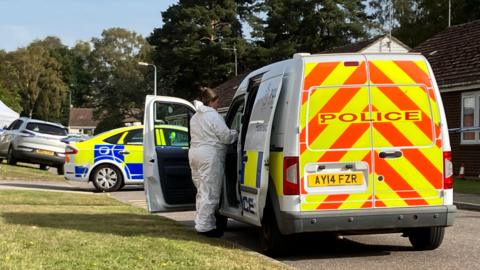 Forensics and police at the scene of an alleged murder in Sutton Heath, Suffolk