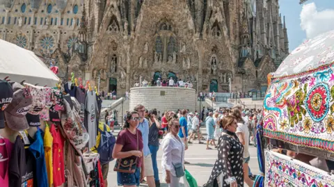 Getty Images Crowds of sightseers outside Sagrada Familia