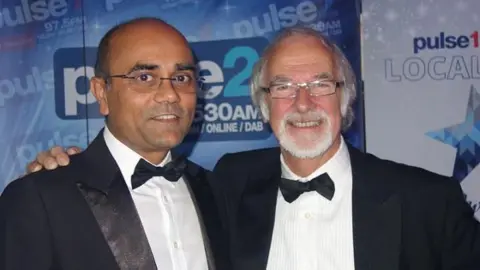 University of Bradford Prof Ajay Mahajan with Prof David Sharpe. Both are wearing tuxedos.