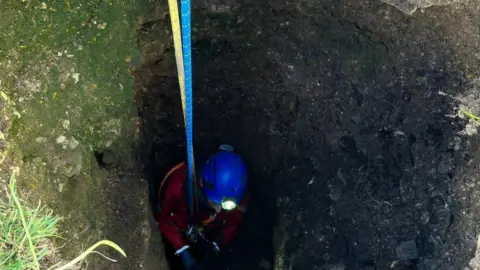 Derbyshire Cave Rescue Organisation Cave rescue volunteer going down a mine