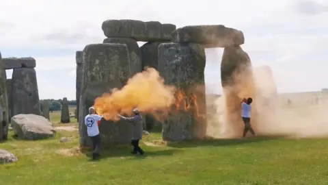 Just Stop Oil Stonehenge being sprayed with orange powder