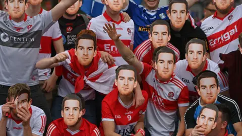 Derry fans wearing Benny Heron masks