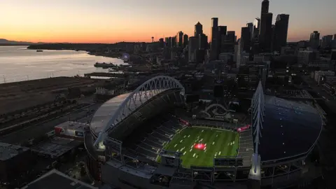 Getty Images A football stadium in Seattle, Washington, with the city's skyline in the background. 