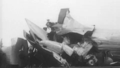 Black and white footage of a plane crash