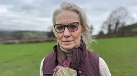Chair of Save Amber Valley Environment Group Catherine Harris wearing glasses and purple gilet jacket