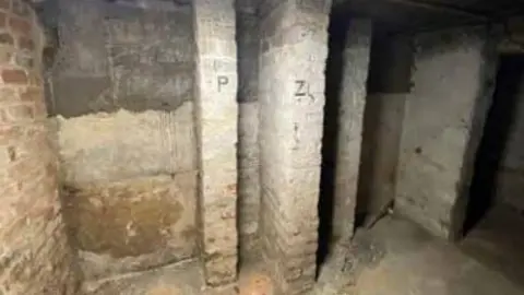 Inside the shelter shows existing brick piers with lettering system assumed to organise public users of air raid shelter.