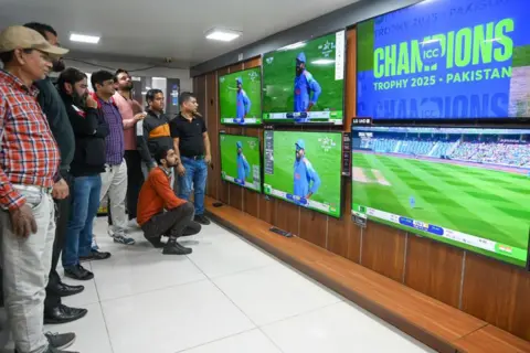 Getty Images People met in a television store in sector 18 to watch the India-Pakistan match of the ICC 2025 champion trophy, on February 23, 2025 in Noida, India.