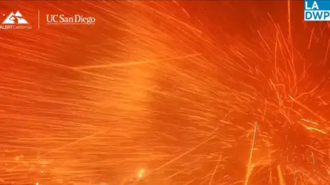 Glowing orange embers fly across the screen