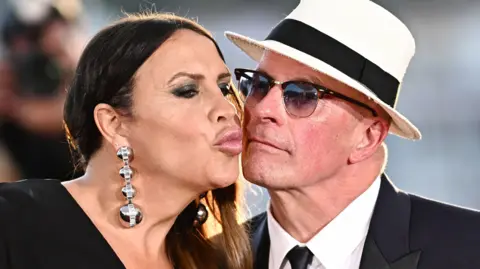 Getty Images Spanish actress Karla Sofia Gascon (L) kisses French director Jacques Audiard as she poses during a photocall with a trophy after she and the rest of the female cast won the Best Actress Prize for theit part in the film "Emilia Perez" and French director Jacques Audiard, after winning the Jury Prize during the closing ceremony at the 77th edition of the Cannes Film Festival in Cannes, southern France, on May 25, 2024.