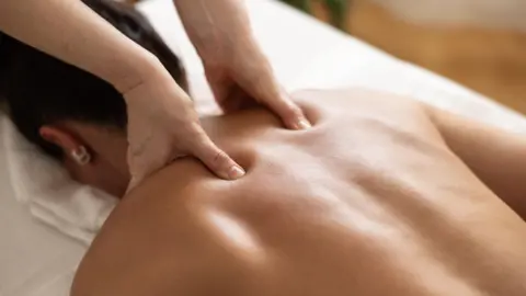 SimpleImages via Getty Images Woman getting a massage.