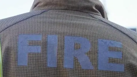 The back of a firefighter's jacket, with FIRE written on it