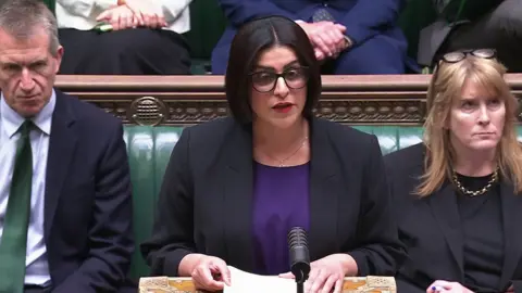 Screen grab of Home Secretary Shabana Mahmood issuing a statement in the House of Commons following the murder of Henry Nowak. She has glasses, a purple top, and a black blazer. 