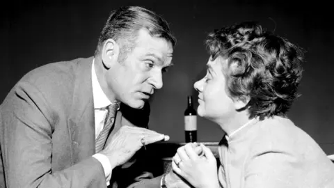 PA Media Black and white photo of Laurence Olivier and Joan Plowright facing each other during rehearsals for The Entertainer