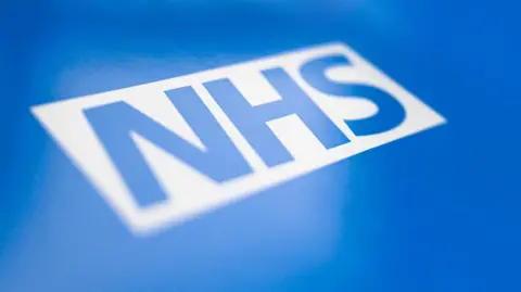 The NHS logo. Blue lettering within a white rectangle, on a blue background.