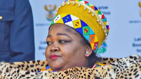 Getty Images Queen Ntokozo kaMayisela wearing traditional Zulu headdress and leopard skin shawl