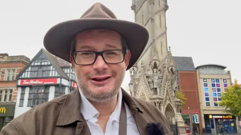 LDRS Jim Butler wearing dark glasses and a cowboy style hat