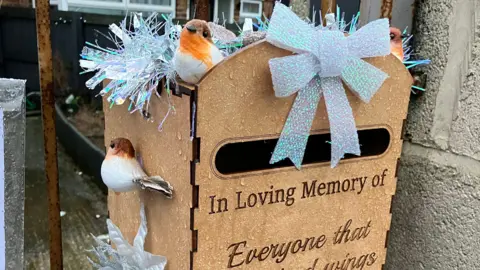 Letterbox with birds and the message "in loving memory of everyone that..."