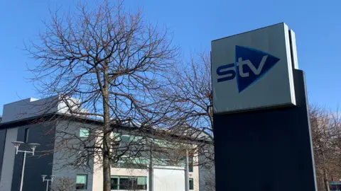 A general view of the STV sign outside its headquarters in Glasgow on a sunny day.