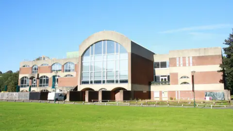 Getty Images A large University of Sussex building, with green grass in front and clear sky