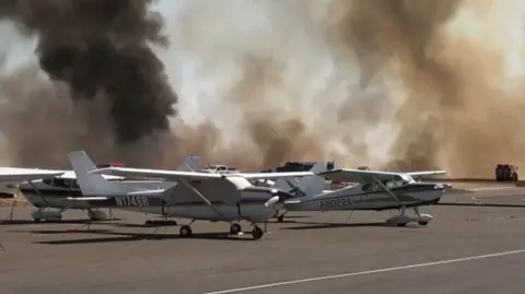 Aircraft surrounded by smoke from surrounding wildfire in California, USA