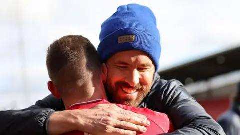 Paul Mullin embraces Wrexham co-owner Ryan Reynolds 