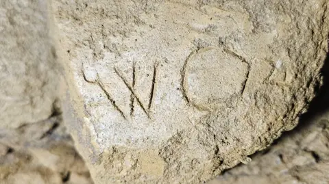 Bloxham Underground Tunnel Society A stone which has "WO" carved into it.