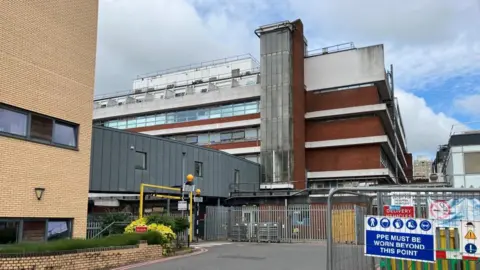 Sam Read/BBC Hospital buildings with several floors and a construction site in the foreground
