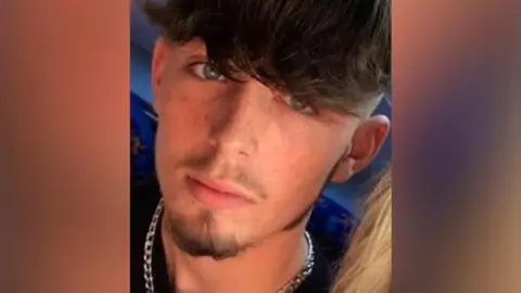 Family handout A teenage boy with dark hair wearing a silver chain