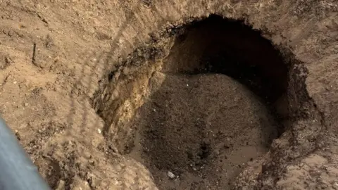 HM Coastguard Large hole with orange cordon